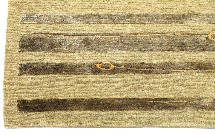 Hand-knotted Modern Tibetan Ariana rug in wool and silk featuring a geometric pattern in gold and greenish hues