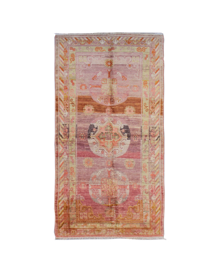 Vintage antique Samarkand Khotan hand-knotted wool runner measuring 7'11" x 3'9" featuring a geometric medallion design in purple, pink, reds, and mauve.