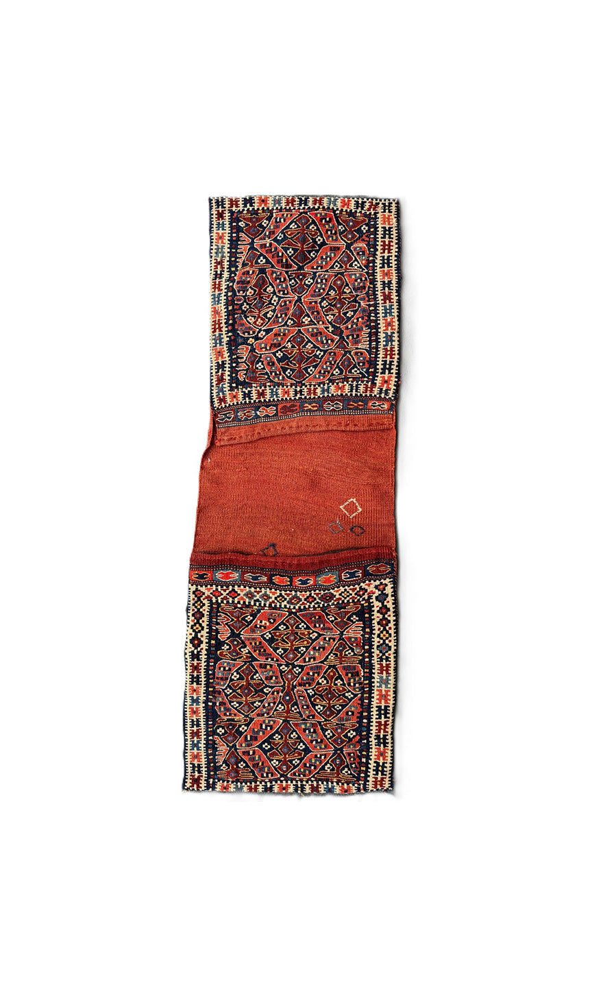 Long vintage Shahsavan Persian tribal saddle bag with terracotta and navy geometric patterns.