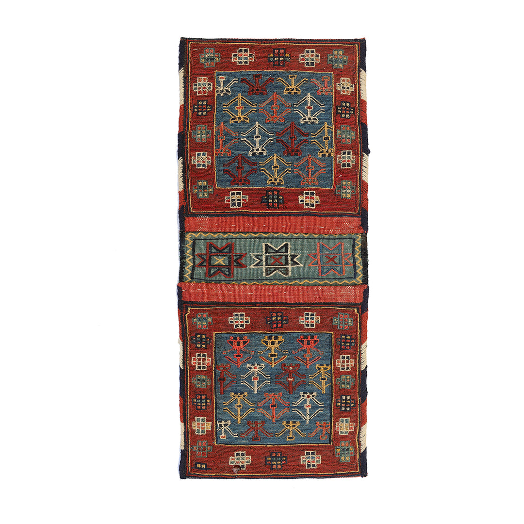 Small vintage Shahsavan Persian Soumak saddle bag with detailed blue and red geometric weaving.