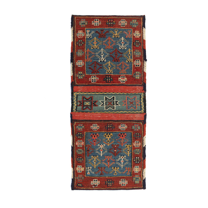 Small vintage Shahsavan Persian Soumak saddle bag with detailed blue and red geometric weaving.