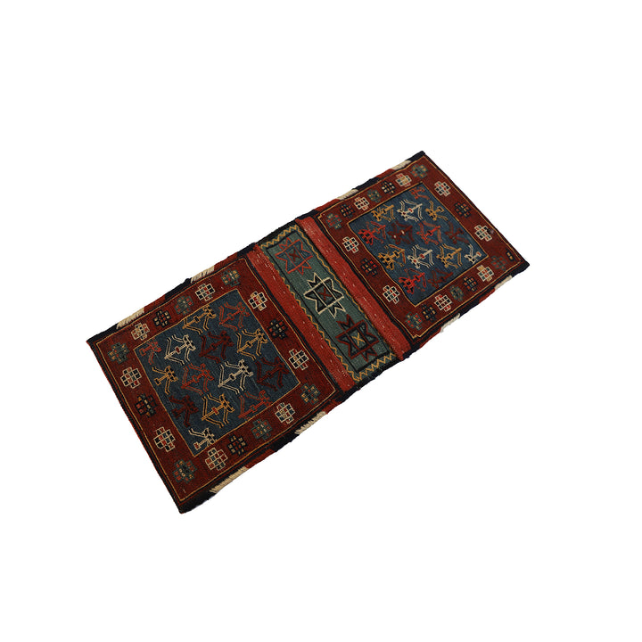 Small vintage Shahsavan Persian Soumak saddle bag with detailed blue and red geometric weaving.