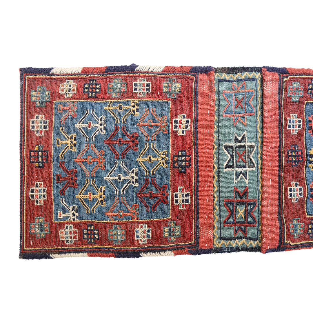 Small vintage Shahsavan Persian Soumak saddle bag with detailed blue and red geometric weaving.