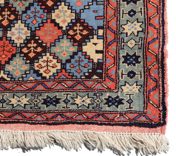 4x4 square Caucasian design wool rug with colorful geometric tribal motifs in 3 foot 10 inch by 3 foot 5 inch dimensions