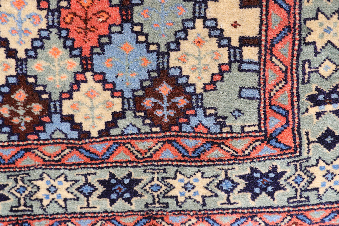 4x4 square Caucasian design wool rug with colorful geometric tribal motifs in 3 foot 10 inch by 3 foot 5 inch dimensions