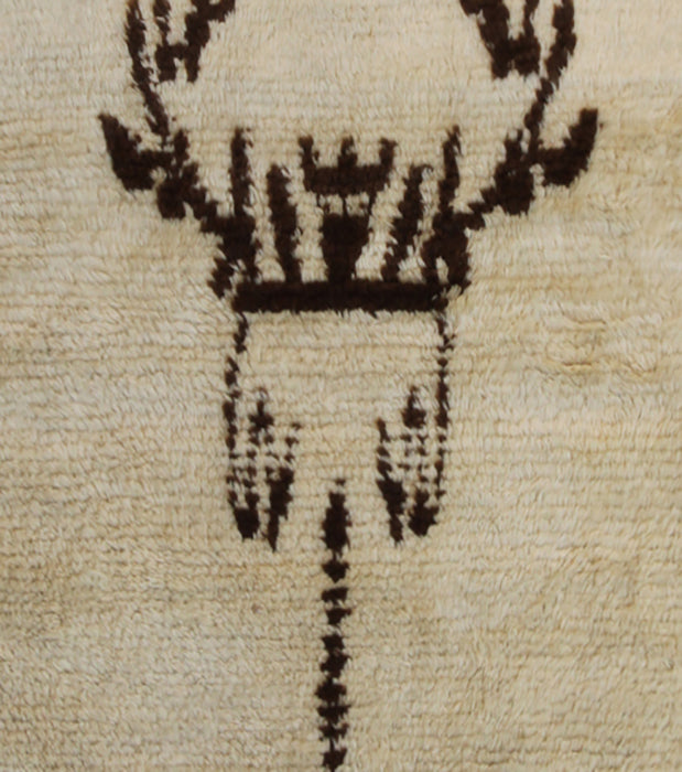 A small 3x5 vintage Turkish Tulu rug with a shaggy ivory wool pile and a minimalist brown tribal geometric design.