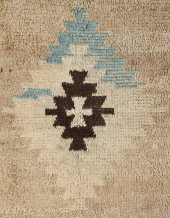 A 4x7 vintage Turkish Tulu rug featuring a shaggy brown wool pile with a central blue/brown medallion and four corner motifs.