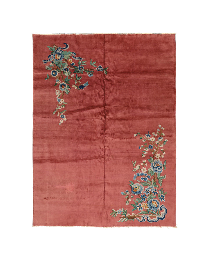 A 9x11 vintage Chinese Art Deco wool rug with a soft salmon pink background and sage green floral accents in the corners.