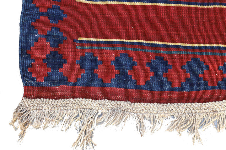 Vintage Caucasian flat-weave kilim rug with colorful vegetable-dyed geometric stripes and diamond motifs in terracotta red, green, and brown