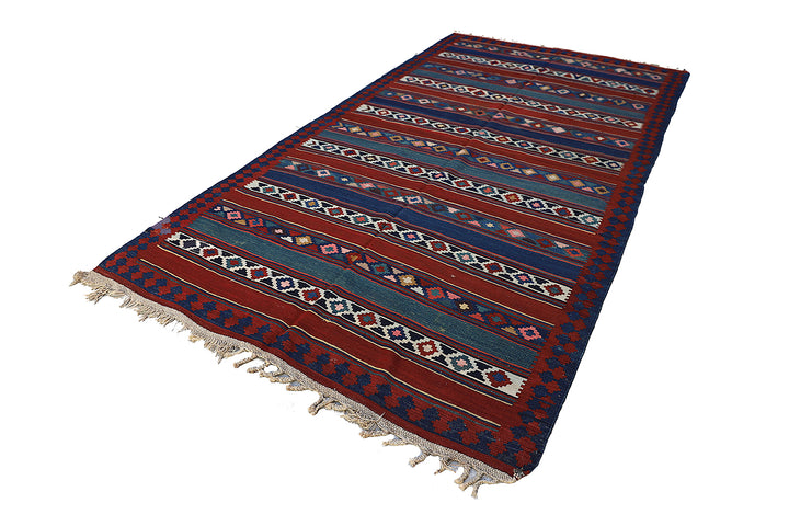 Vintage Caucasian flat-weave kilim rug with colorful vegetable-dyed geometric stripes and diamond motifs in terracotta red, green, and brown