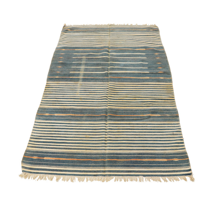 Striped rug with blue and beige pattern on a white background