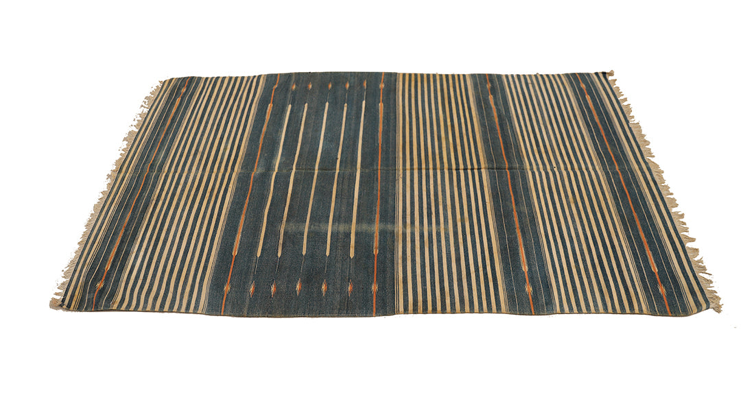 Striped rug with black and beige pattern on a white background