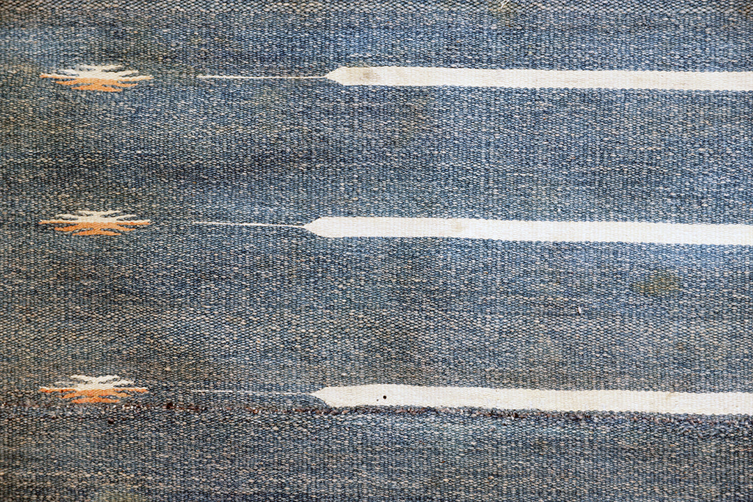 Textured blue surface with white and gold abstract patterns