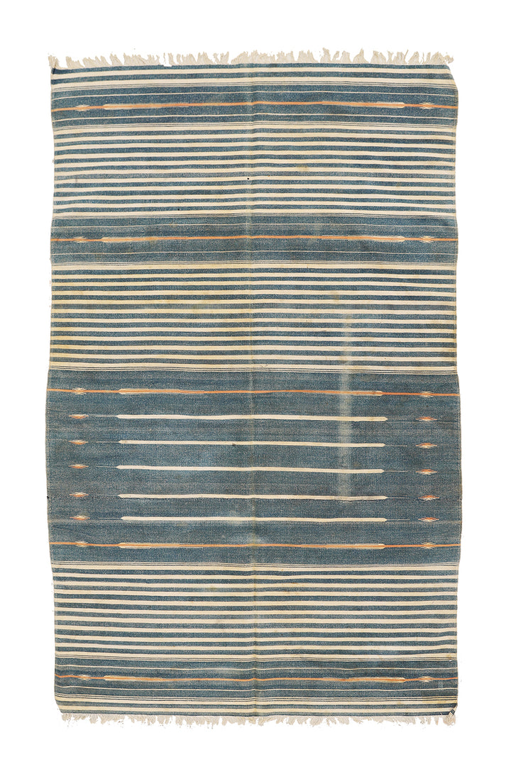 Striped blue and beige rug on a white background