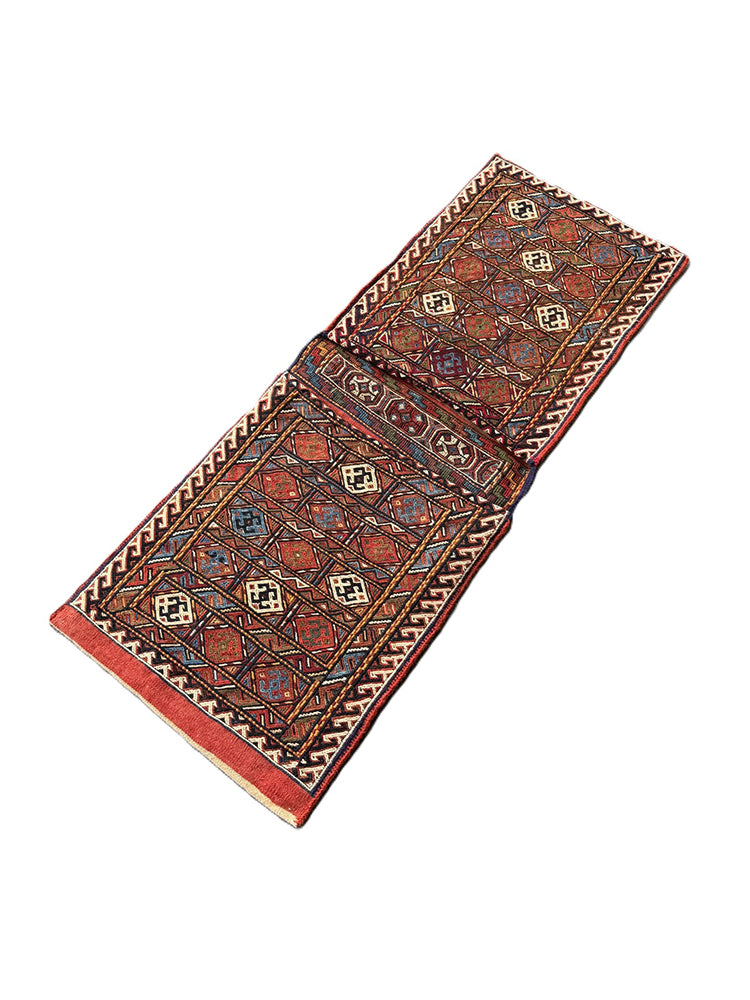 Pristine Persian tribal dowry saddle bag with intricate geometric wool weaving.