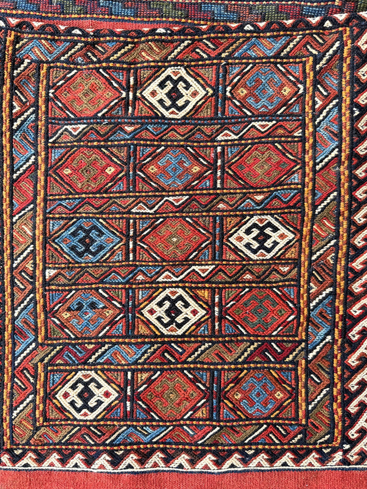 Pristine Persian tribal dowry saddle bag with intricate geometric wool weaving.