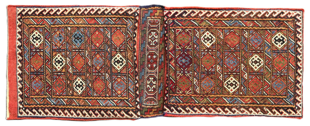 Pristine Persian tribal dowry saddle bag with intricate geometric wool weaving.