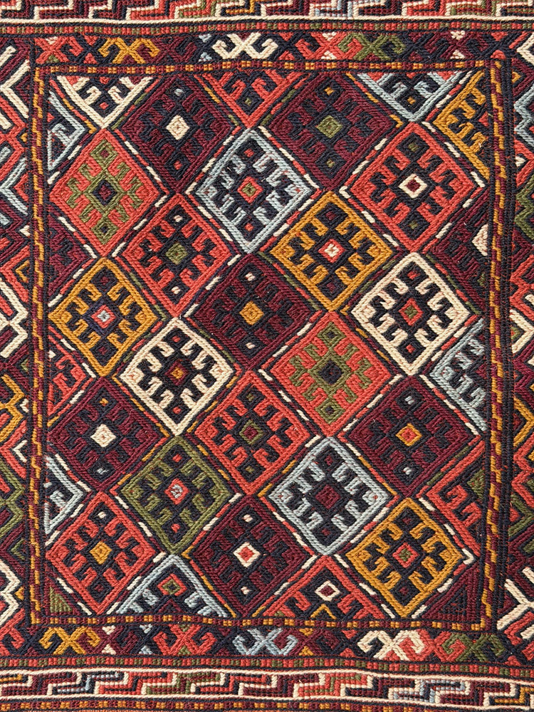 Pristine Persian tribal dowry saddle bag with intricate geometric wool weaving.