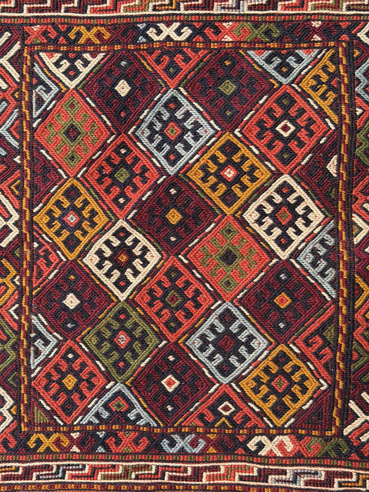 Pristine Persian tribal dowry saddle bag with intricate geometric wool weaving.