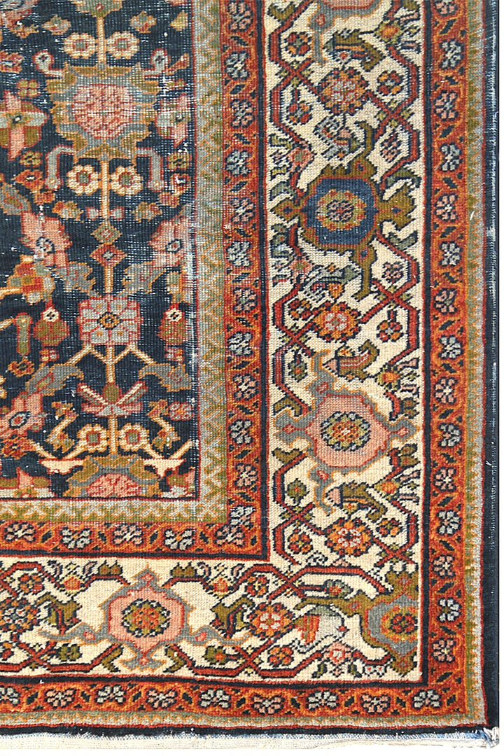 1920s vintage Persian Mahal rug 9x12 featuring a navy blue geometric pattern with terracotta, white, and gold accents.
