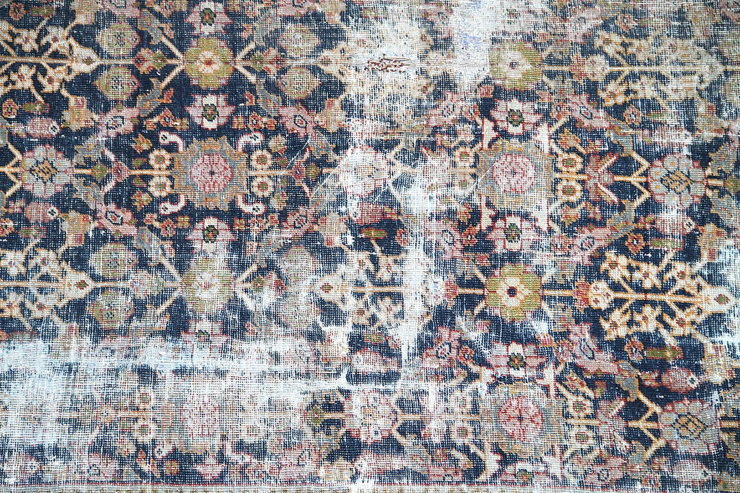 1920s vintage Persian Mahal rug 9x12 featuring a navy blue geometric pattern with terracotta, white, and gold accents.