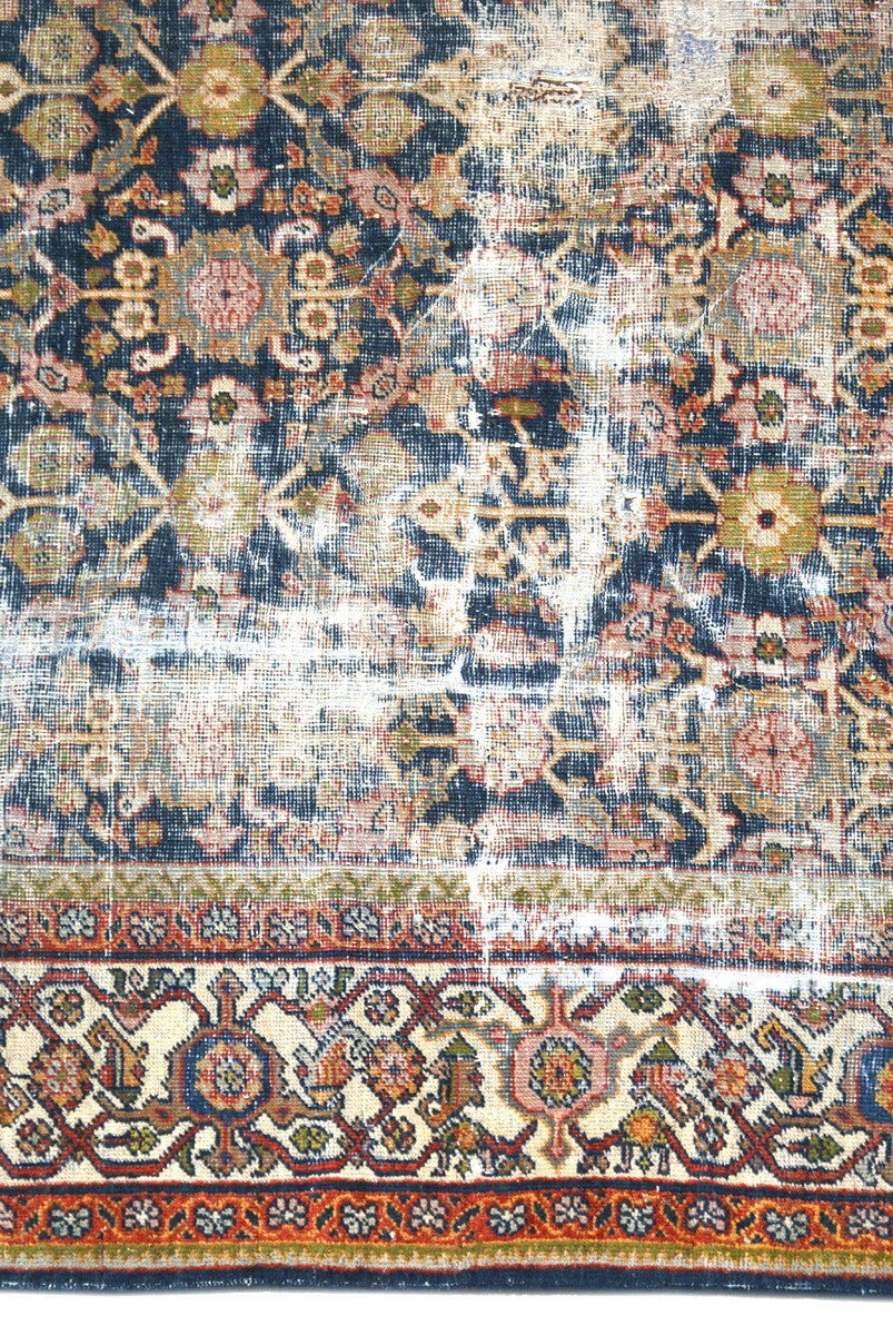 1920s vintage Persian Mahal rug 9x12 featuring a navy blue geometric pattern with terracotta, white, and gold accents.