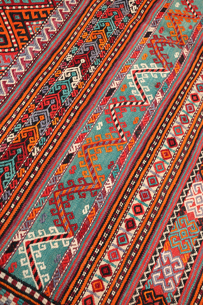 Fine vintage 5'2" x 9'9" Persian Soumak tribal kilim with ivory, red, and teal vegetable dyes, curated by Ariana Rugs in West Hollywood.