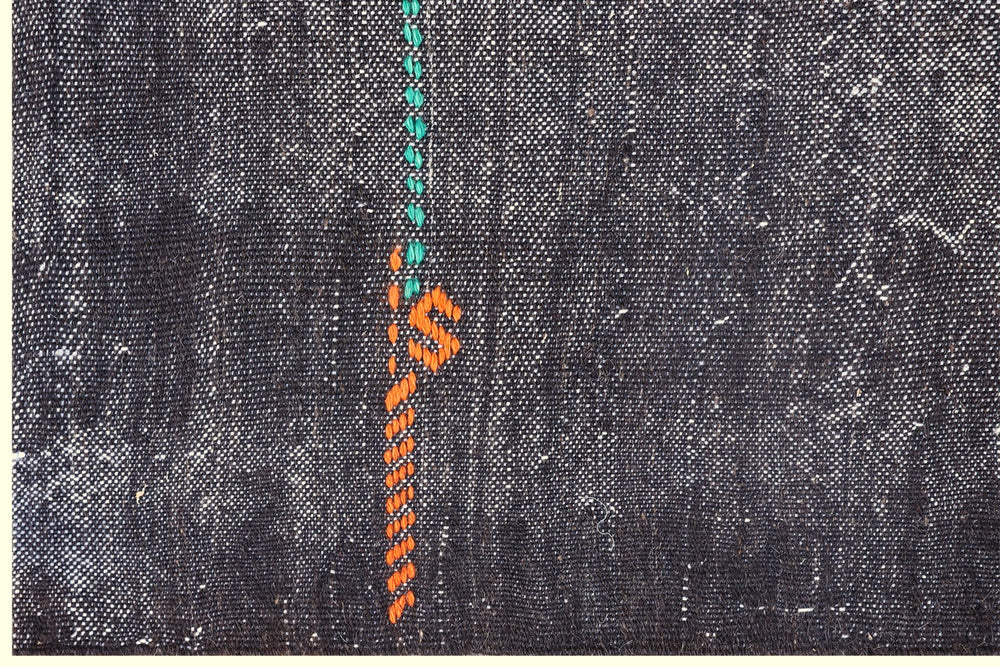 Handwoven vintage Turkish black goat hair kilim rug with colorful tribal modern patterns on navy field