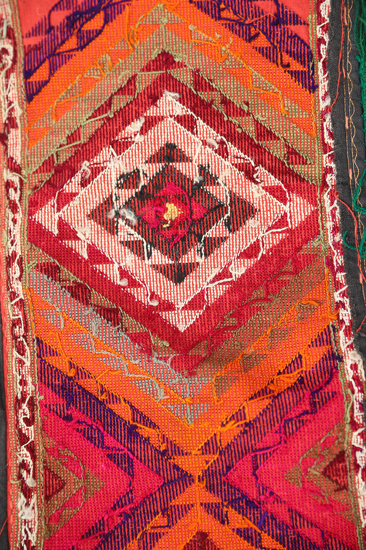 Authentic vintage Uzbek Saye Gosha textile featuring a traditional V-shape design with intricate hand-embroidered tribal floral medallions and decorative trim.