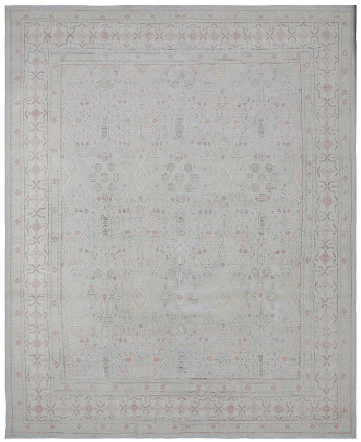 A fine wool and silk rug with an icy blue, pink, and ivory color scheme and a geometric Tabriz design.