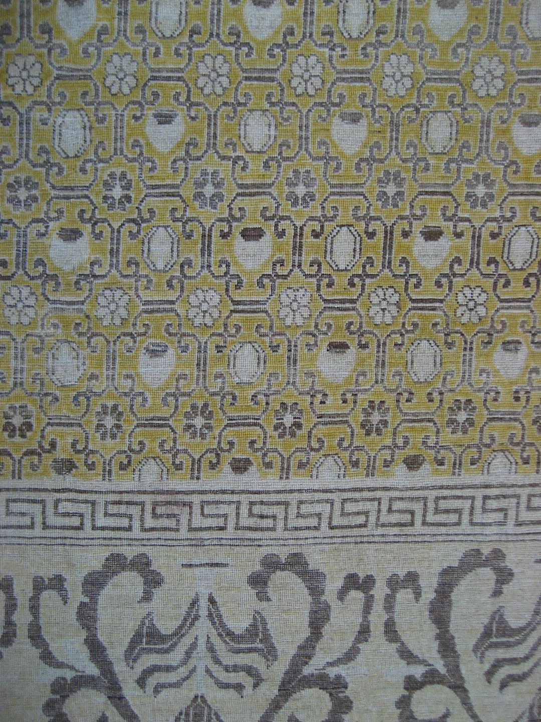 Patterned fabric with geometric design on a yellow and gray background