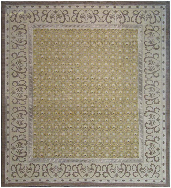 A large rectangular rug with a geometric Khotan design in yellow, beige, and ivory colors, featuring intricate patterns and a decorative border.