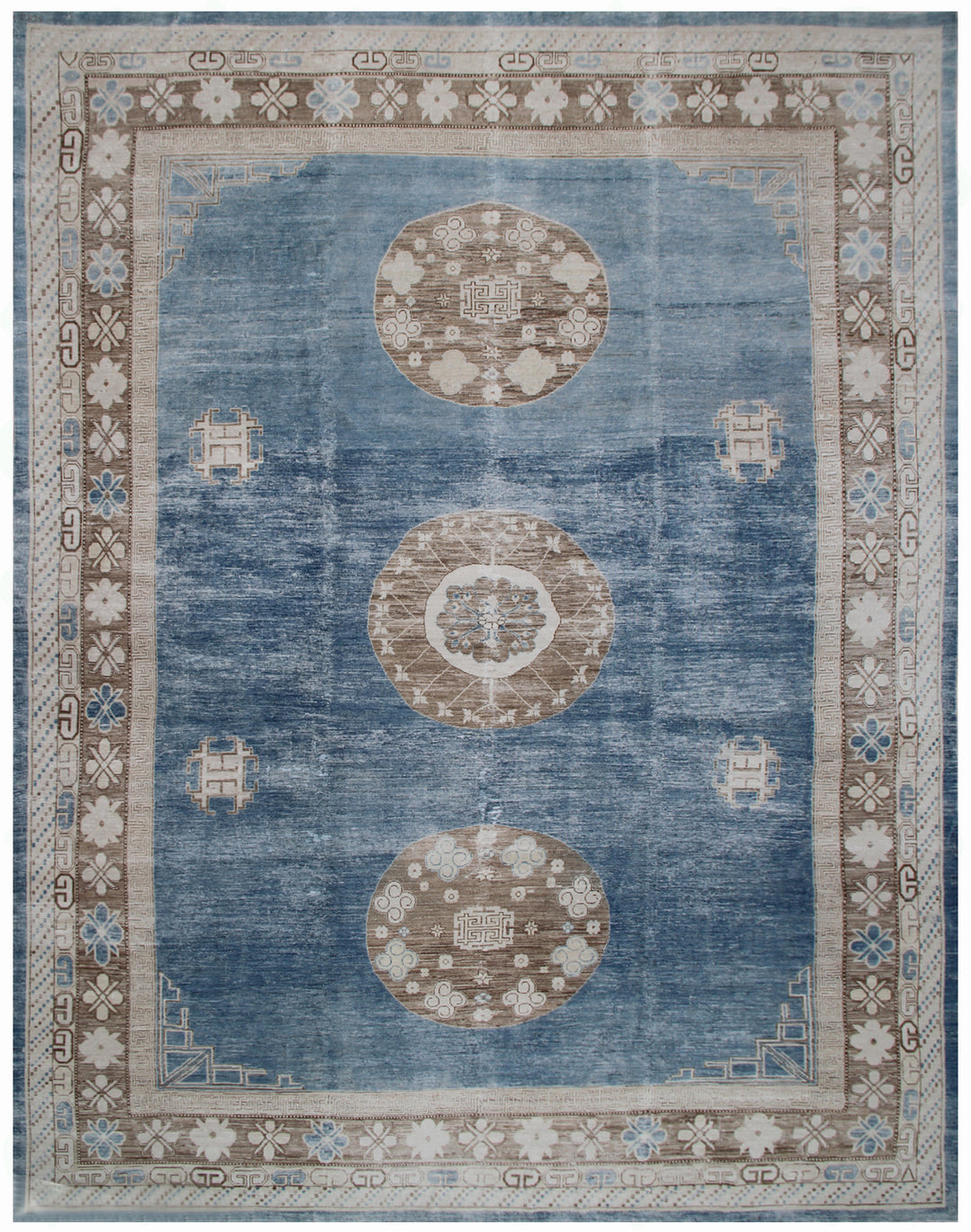 A vintage Ariana rug with a blue field and traditional Khotan geometric designs in beige and brown.
