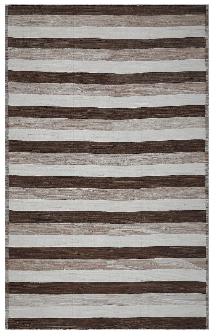 A large rectangular rug with a striped pattern featuring shades of brown and ivory, with a textured and handcrafted appearance.