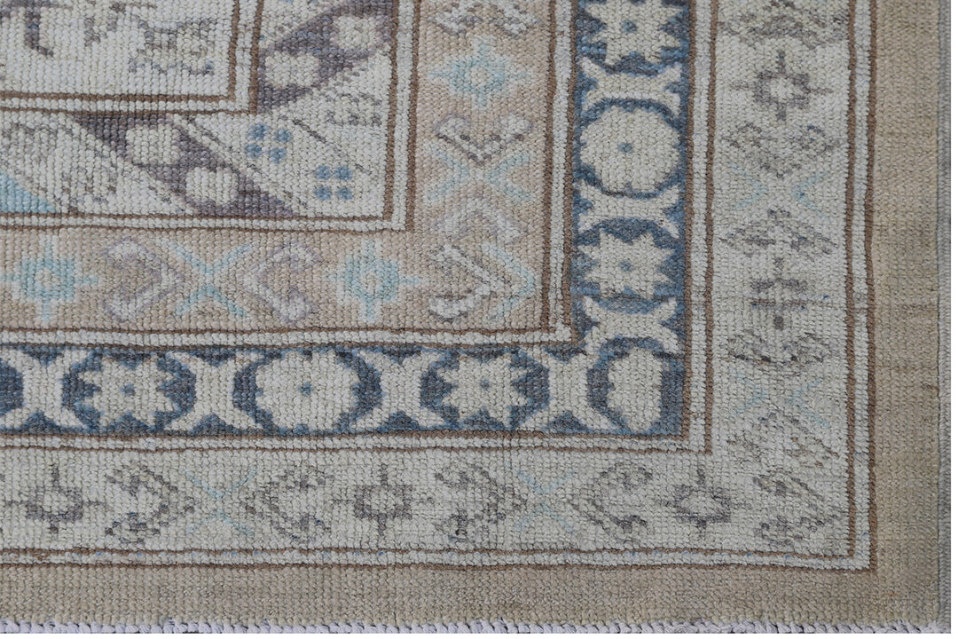 16'4" x 13'2" Large hand-knotted wool Ariana Hazara rug with Caucasian geometric motifs in tan, beige, gold, blue, black, and white.