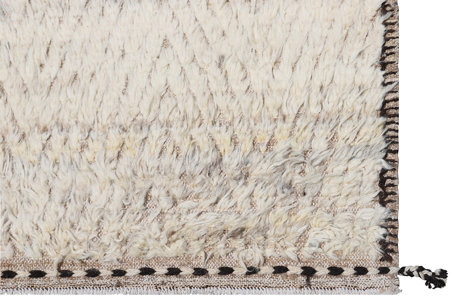 A closeup of the border of a cream ivory and brown high low pile chevron pattern contemporary modern moroccan wool area rug.