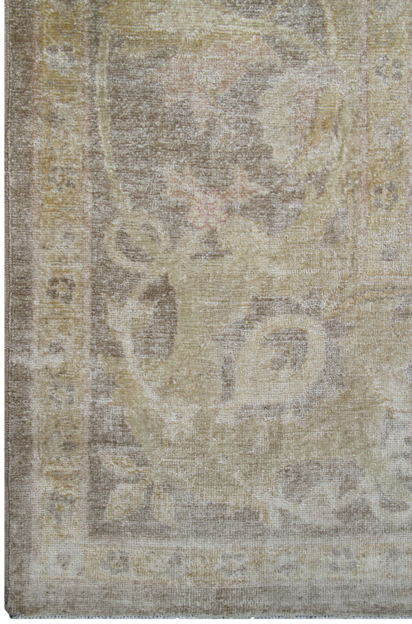 Vintage-style rug with intricate patterns in beige, brown, and gray tones.