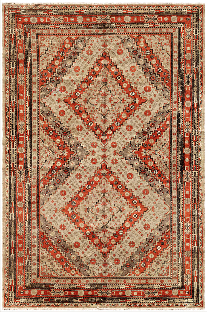 A vintage Samarkand Yarkand rug with geometric design in rust cream and grey ivory colors.