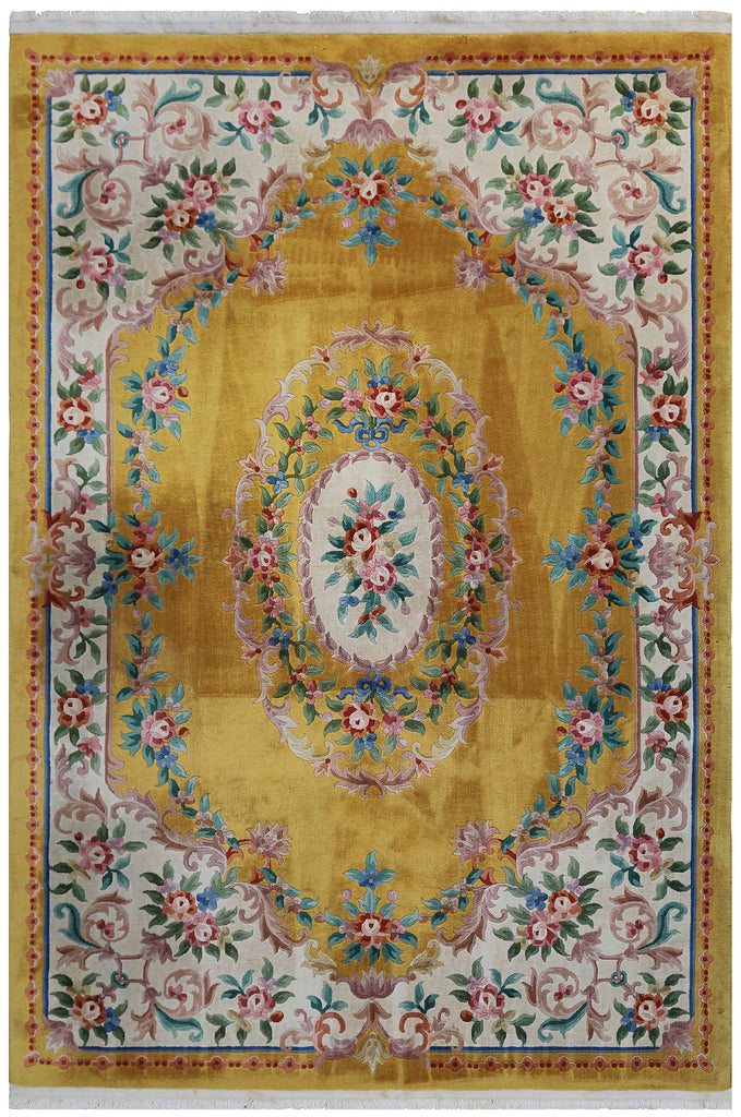 A gorgeous vintage wool rug in a demi lune shape having a pretty rose wreath and ribbon pattern. authentic