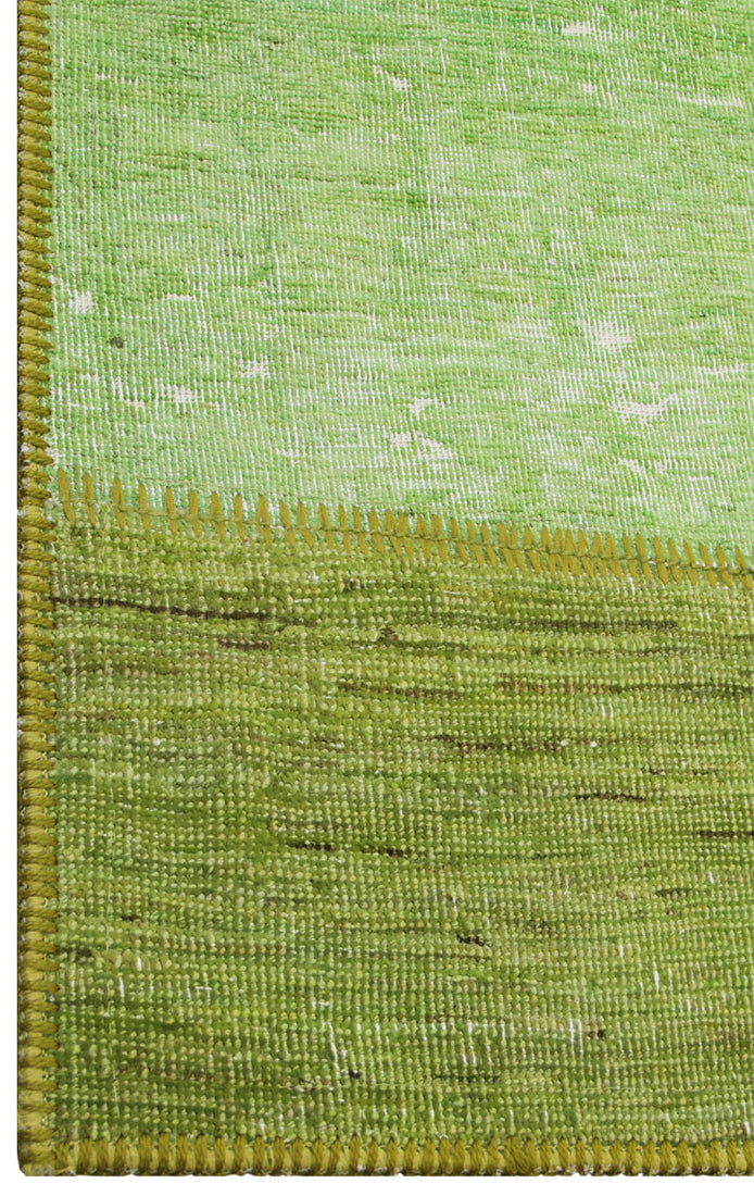 Close-up of a green textured fabric with a yellow border