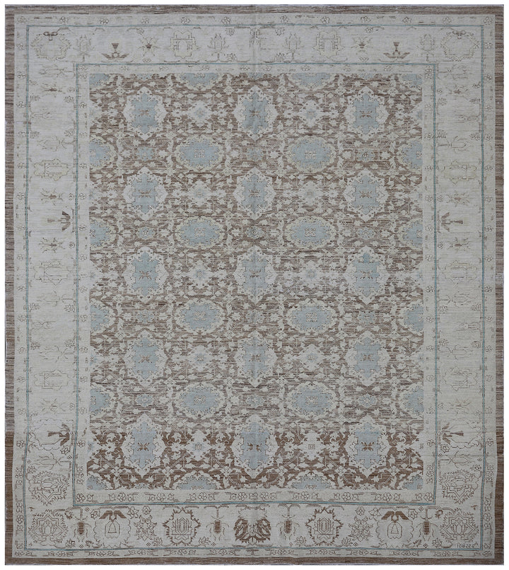 A rectangular, traditional wool rug with a blue and brown floral Agra design pattern.