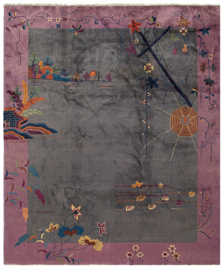 A gray and pink vintage Chinese Art Deco wool area rug with floral and pictorial motifs, showing signs of wear but maintaining a timeless design.