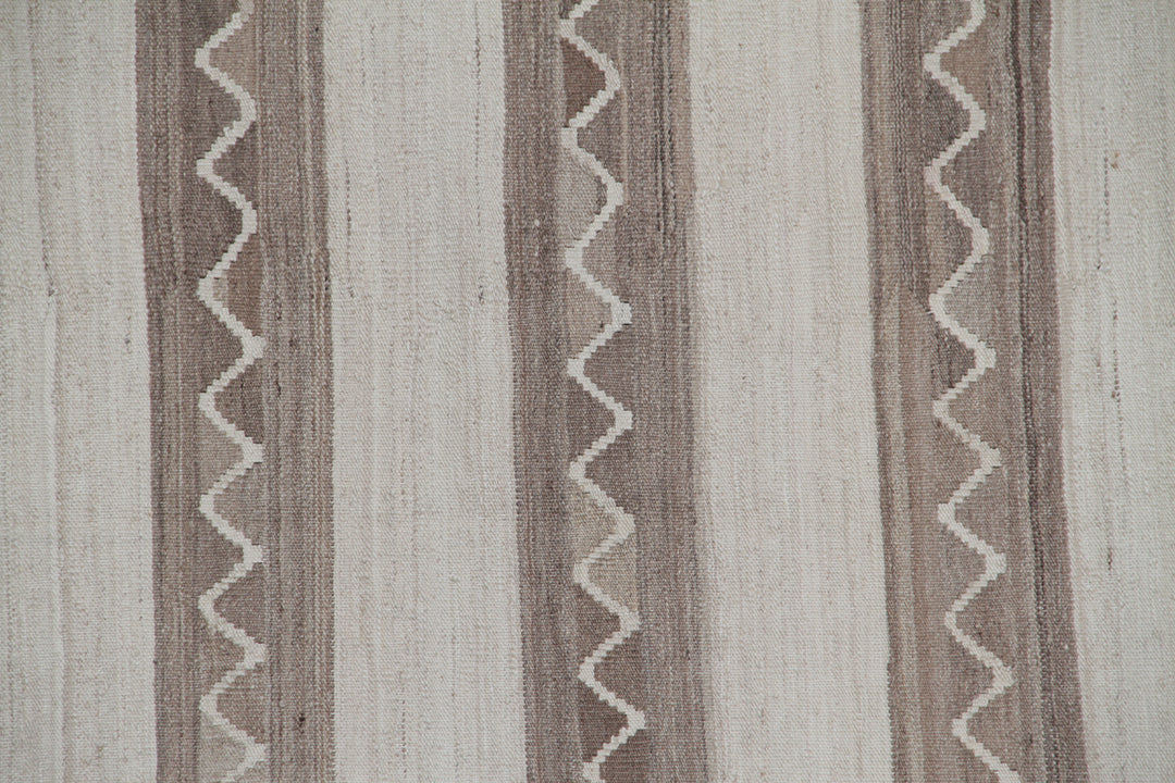 Handwoven beige and brown striped wool kilim with zigzag motif, crafted in Afghanistan. Luxury flatweave rug from the Ariana Kilim Collection.
