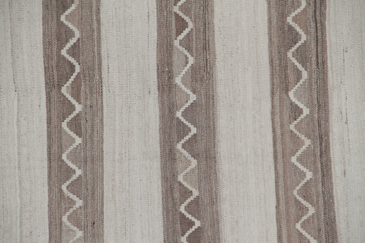Handwoven beige and brown striped wool kilim with zigzag motif, crafted in Afghanistan. Luxury flatweave rug from the Ariana Kilim Collection.