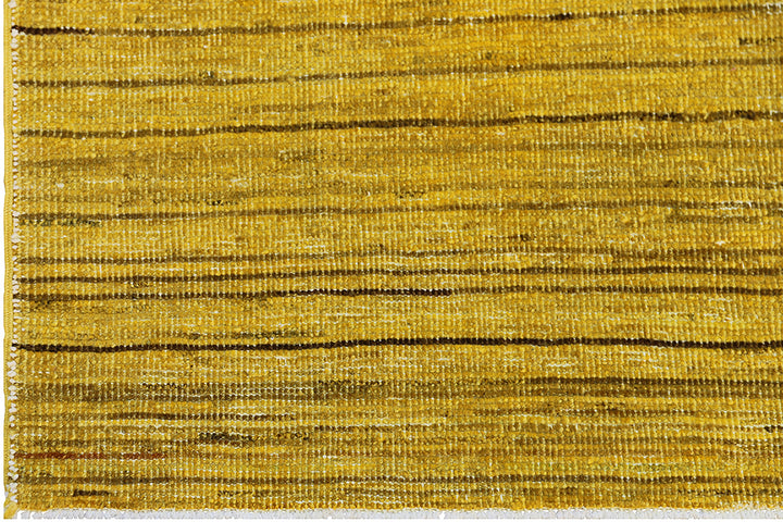 Hand-knotted wool Ariana Over-dye rug with a Mustard Gold and Brown Stria textured design, measuring 8’8” x 5’7”.