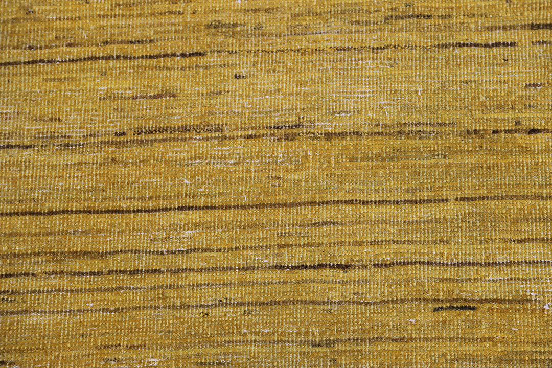 Hand-knotted wool Ariana Over-dye rug with a Mustard Gold and Brown Stria textured design, measuring 8’8” x 5’7”.