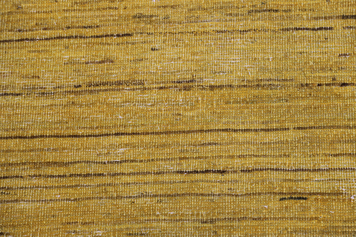 Hand-knotted wool Ariana Over-dye rug with a Mustard Gold and Brown Stria textured design, measuring 8’8” x 5’7”.