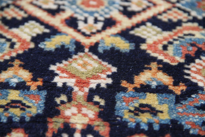 A large 9'4" x 12'2" vintage Khorasan wool rug featuring a navy blue field with intricate geometric patterns and a traditional Persian border.
