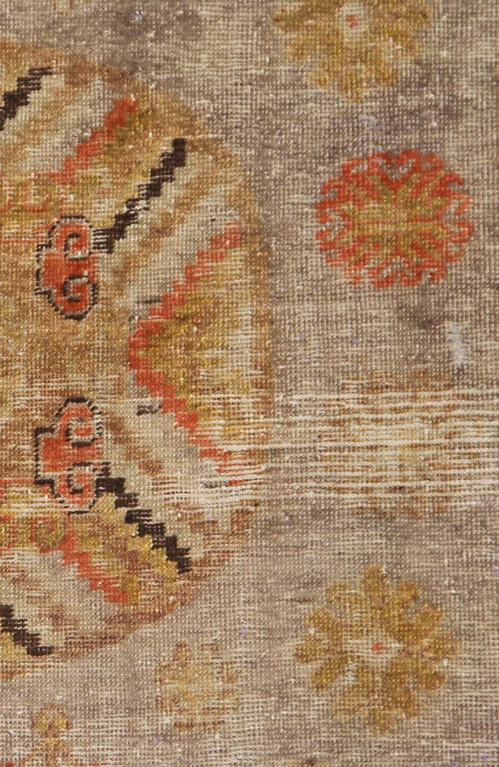 Antique Samarkand hand-knotted wool runner measuring 8'5" x 4'6" featuring an antique red medallion design on a grey, orange, and gold color palette.
