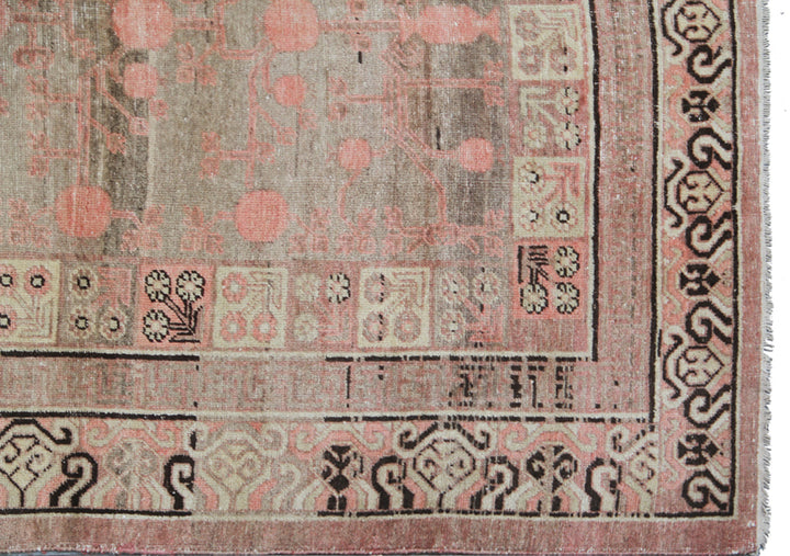 Extra-large antique East Turkistan Samarkand wool rug measuring 7'11" x 16'1" featuring a pomegranate botanical design in grey, pink, brown, beige, and black.